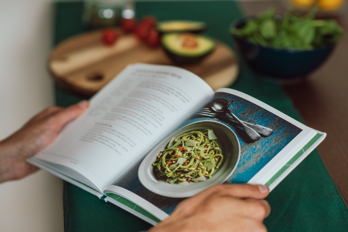 Hands Holding an Open Recipe Book